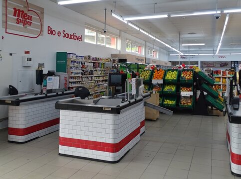 Supermarket checkout area with fruits and vegetables