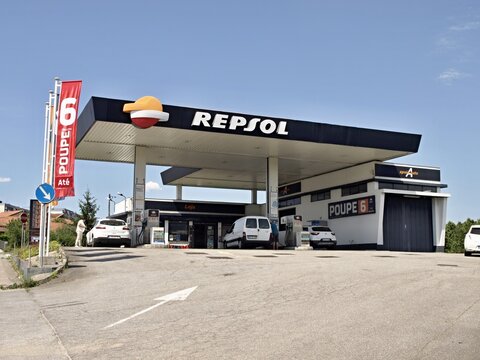 Repsol gas station building with cars refueling fuel