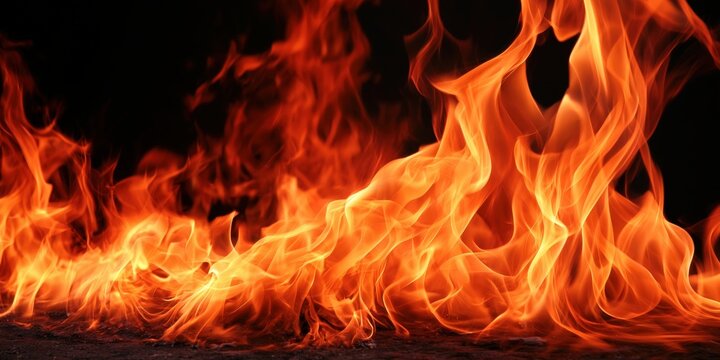 Vibrant flames dance against a deep black backdrop