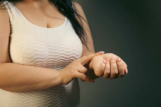 Woman suffering from pain in the elbow. Health care and medical concept.