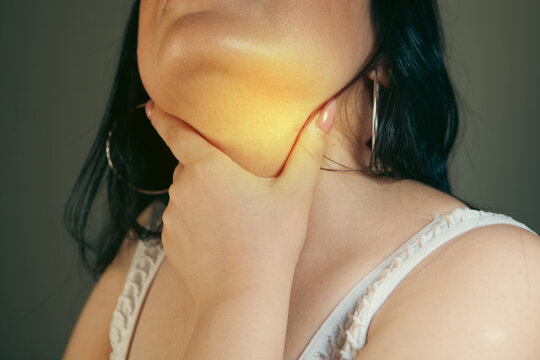 woman suffering from pain in the throat, closeup of her body