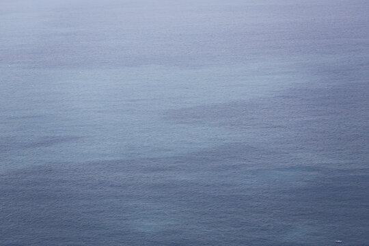 A Distant Boat Crosses the Vast Blue Sea.
