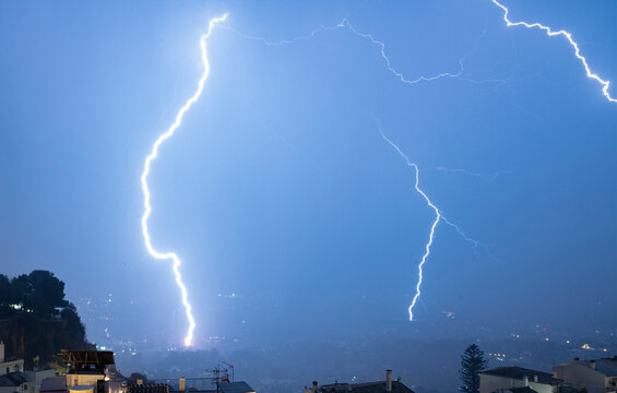 Powerful lightning bolt striking during an intense thunderstorm over Mijas, Andalusia, Spain