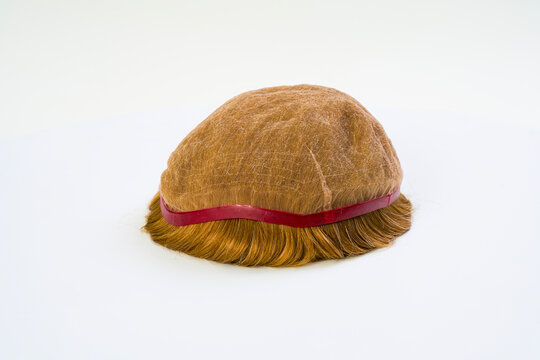 Golden wig on white background