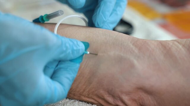 Healthcare Worker Inserting Butterfly Needle During Home Visit