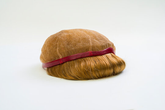 Golden wig on white background