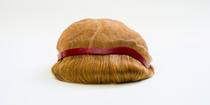 Golden wig on white background