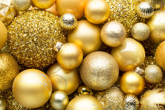 Monochrome  backgraund  of  golden Christmas  ornaments different sizes, shades and textures. Flay lay