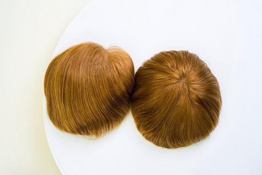 Golden wig on white background