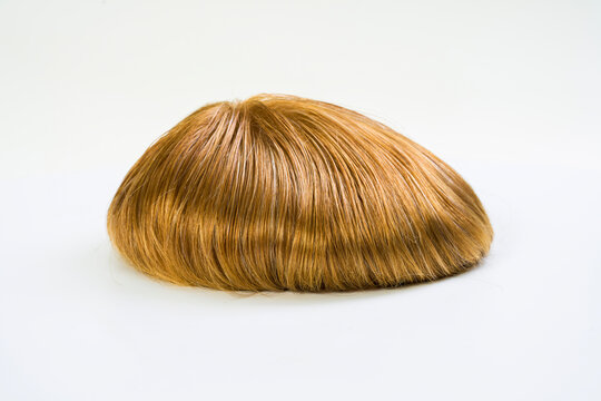 Golden wig on white background