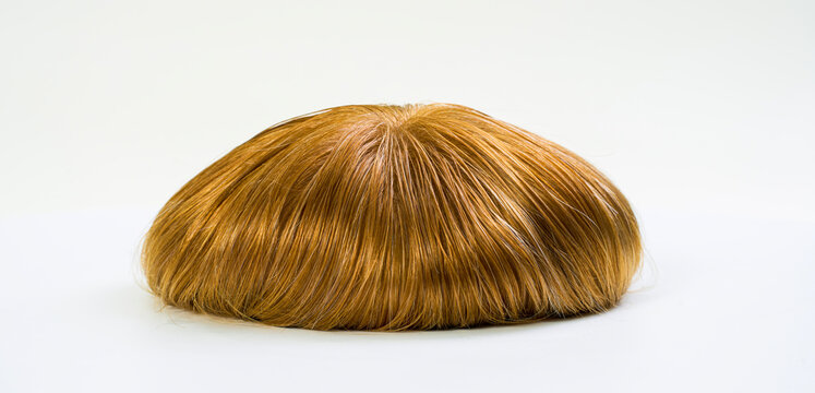 Golden wig on white background