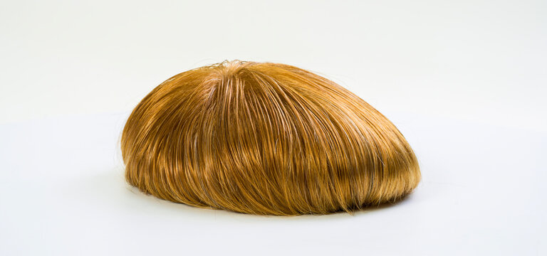 Golden wig on white background