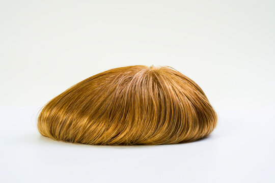 Golden wig on white background