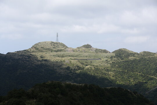 Power Pylon Stands Across a Mountain Ridge.