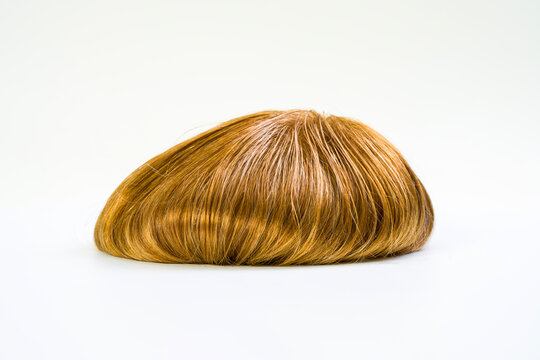 Golden wig on white background
