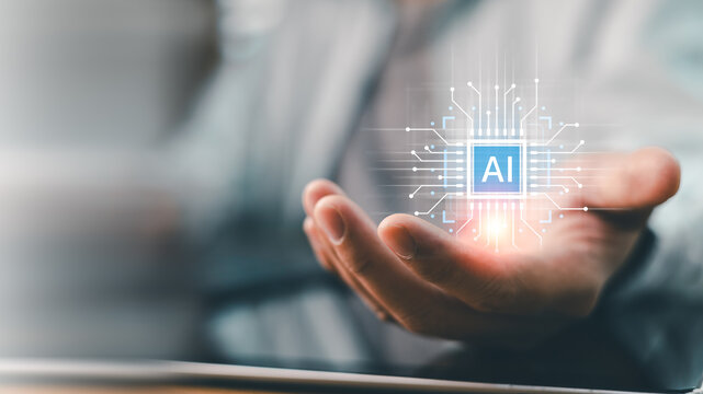 Businessman holding futuristic AI with holographic circuit board connection. Concept of artificial intelligence technology, machine learning, digital transformation and smart computer processor