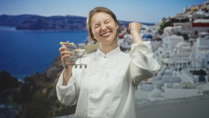 Woman chef holding a miniature shopping cart and doing a fist pump in studio  joy celebration success. © Krakenimages.com
