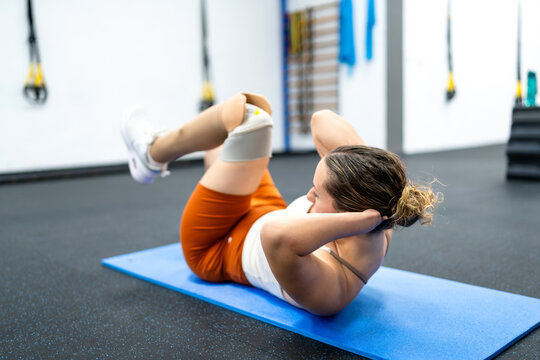 Woman with prosthetic leg training in gym showing strength and self-improvement