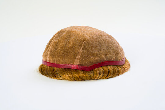Golden wig on white background