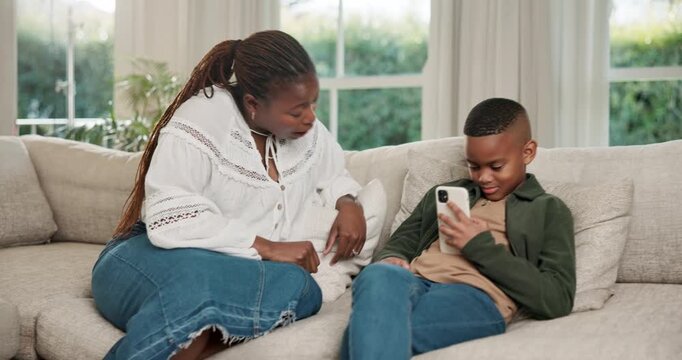 Conversation, child and ignoring mom with phone on sofa for bad behavior, distraction or discipline. Black family, mother and talking with son on smartphone for addiction, concern or limit in house