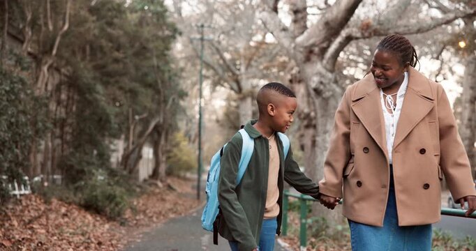 Mom, sidewalk and holding hands with black child for school, conversation or outdoor safety. Mother, listening and walking with boy, kid or son for happy discussion, education or learning journey
