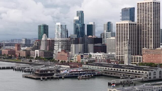 Ferry Building With Iconic Clock Tower On Embarcadero Waterfront On Cloudy Morning In San Francisco, California. Drone sideways shot