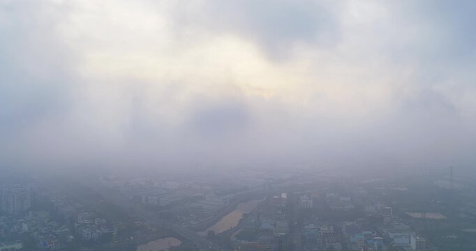 Aerial view of Saigon cityscape at morning with misty sky in Southern Vietnam. Urban development texture, transport infrastructure and green parks