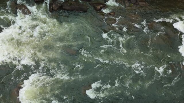 Overhead drone view of whitewater rapids churning over rocks on the Ocoee River.