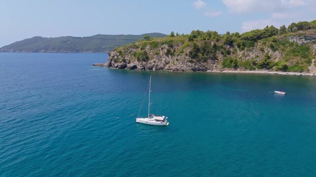 Aerial view of yachts and sailboats navigating the tranquil waters of Lacona Bay near Lacona, Elba Island, Tuscany, Italy, under a clear summer sky.