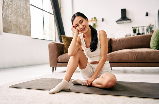 oman resting on yoga mat at home