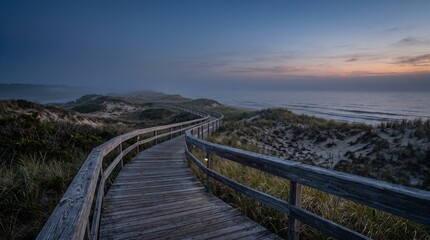 Fototapeta premium Sunset Over Mountain Coast with Ocean, Sandy Beach, Green Grass, Wooden Boardwalk and Dramatic Clouds in a Scenic Summer Landscape