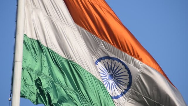 India flag flying high at Connaught Place with pride with plain white background, India flag fluttering, Indian Flag on Independence Day and Republic Day of India, tilt up shot, Har Ghar Tiranga