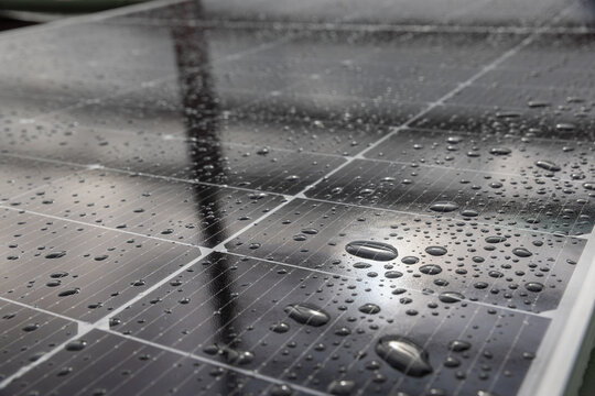 Improperly angled solar panel showing  surface with water drops on glass.