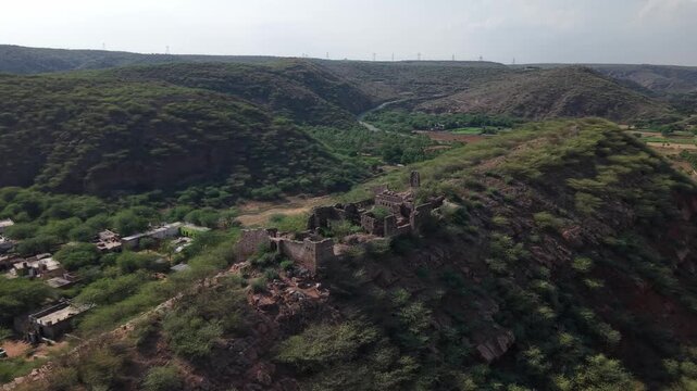 Aerial view of ancient Nuh Fort ruins surrounded by Aravalli landscape, India