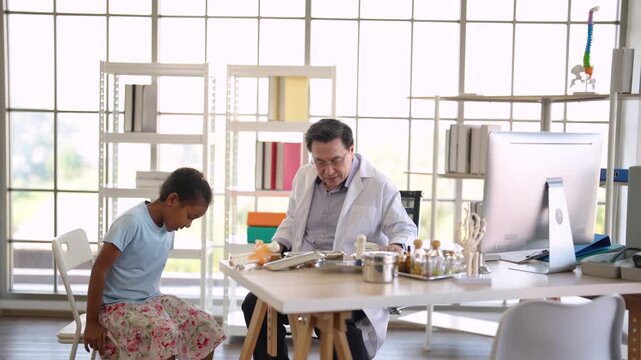 Senior physician assessing child leg injury during medical consultation, pediatric examination, orthopedic evaluation, healthcare service, clinical diagnosis, patient treatment.