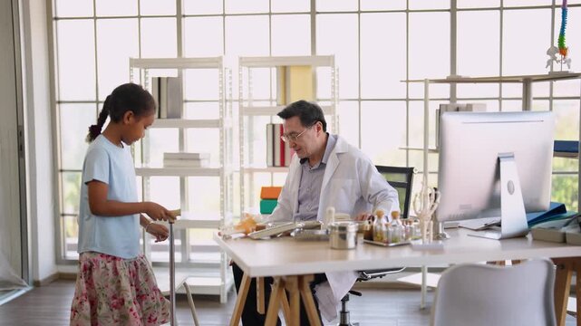 Doctor performing physical examination for child with injured leg, pediatric clinic, orthopedic healthcare, medical consultation, injury diagnosis, hospital care.