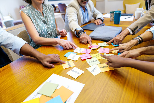 Diverse business professionals collaborating, discussing strategy, and developing new ideas during a brainstorming session in a modern office
