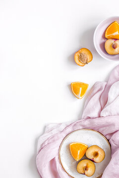woman summer breackfast with orange and peach fruits and fabric on white background flat lay mockup