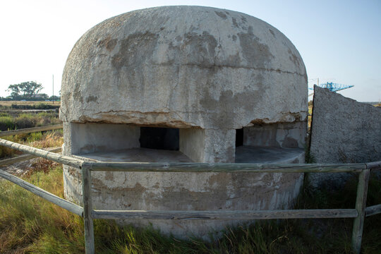 Historic concrete World War II military bunker and coastal watchtower found in salt flats of Santa Pola, Spain
