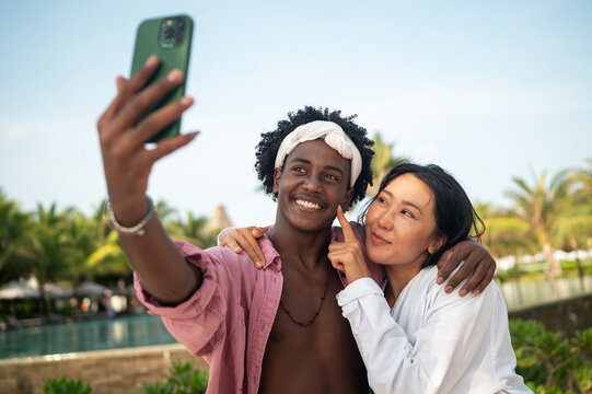 Happy moments by the beach, friends enjoying mobile connection, social media, and summer vibes