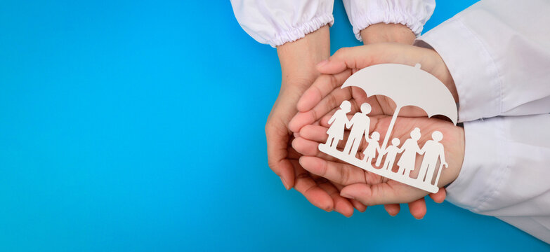 Reassuring hospital patient safety program supports family health protection insurance with caring doctor holding paper cutout
