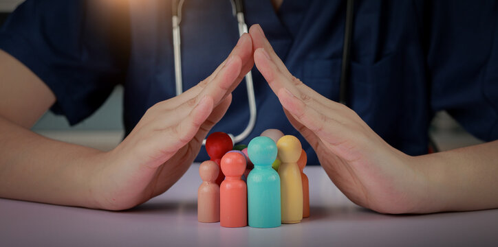 Caring nurse hand protect wooden family figurine representing hospital patient safety program with compassionate hopeful gesture