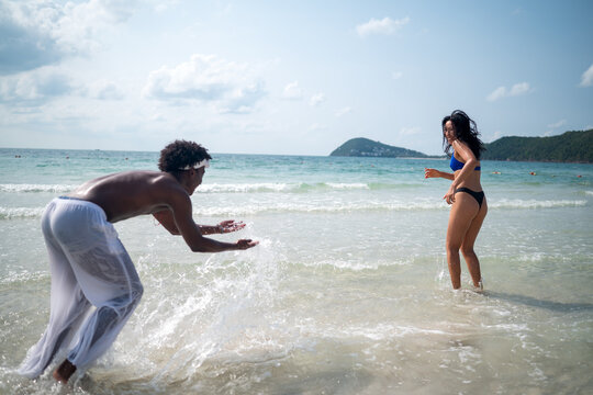 Pure happiness. A young diverse, multiethnic couple enjoys every moment of their tropical getaway