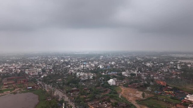 Cinematic drone view of Nuh town under overcast sky, Haryana