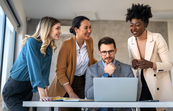 Group of young business people working as a team and communicating in corporate office