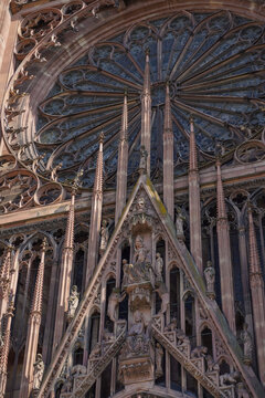 Detailed ornate gothic facade of a historic European cathedral with intricate stone carvings and a rose window.