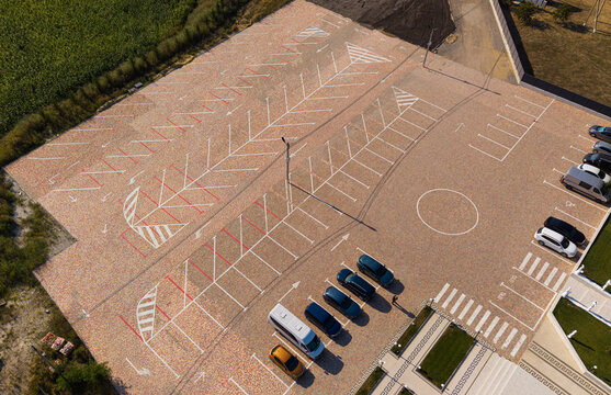 Parking lot top down aerial drone view with white marking lines and pavement texture, urban infrastructure concept
