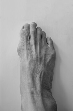 Close up of senior man foot on white background with copy space.