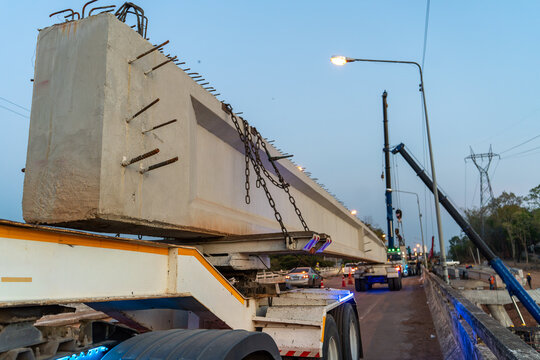 Precast Concrete Bridge Girder Transported for Highway Bridge Construction at Infrastructure Project Site