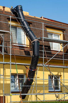Vertical view of a house reconstruction project with a plastic waste chute